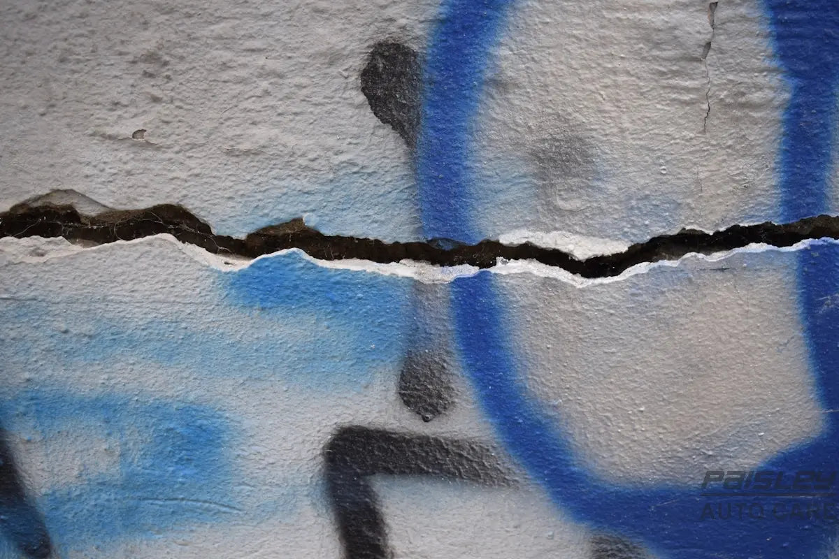 a blue and white wall with a crack in it