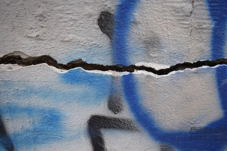 a blue and white wall with a crack in it