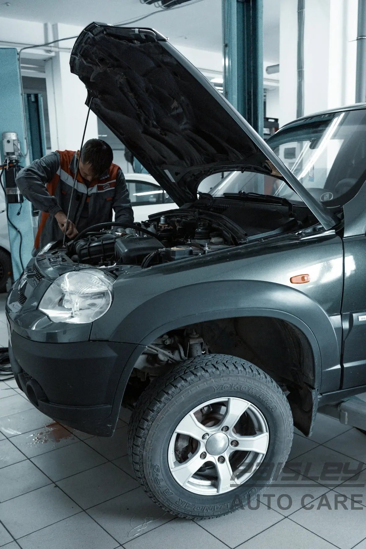 man in black jacket standing beside black car