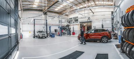 A car is parked inside of a garage