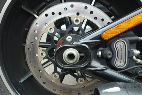 A close up of a motorcycle wheel and brake