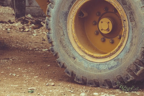 a close up of a yellow wheel on a truck