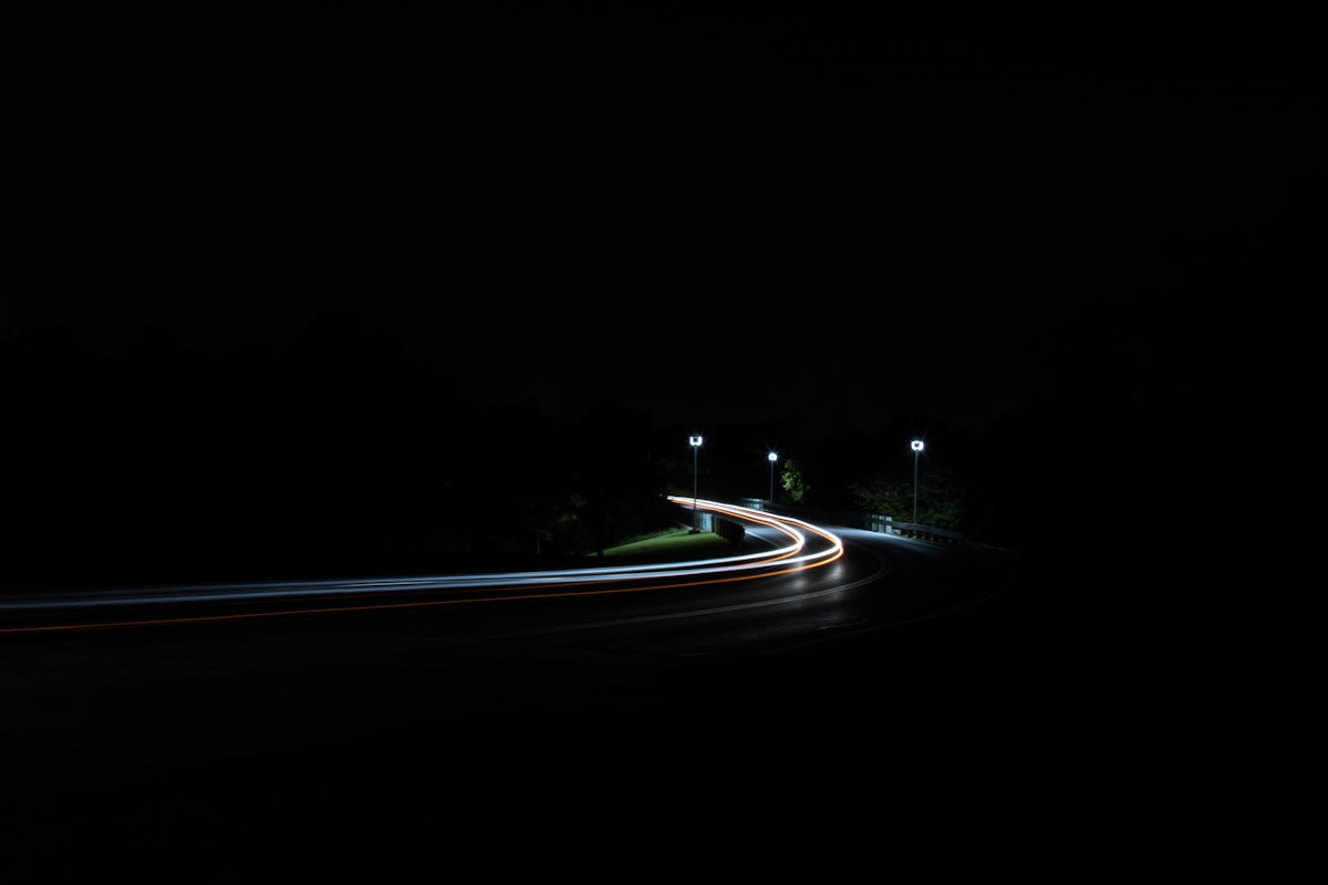 time-lapse photography of moving vehicles on road