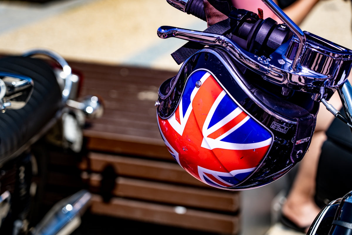 a helmet on the back of a motorcycle
