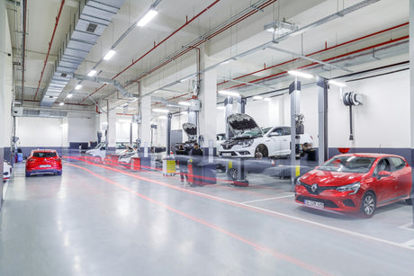 A red car is parked in a garage