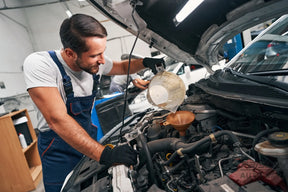 "Mechanic changing oil and air filters during a full car service in Paisley